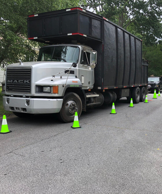 debris hauling truck with high visibility safety road cones
